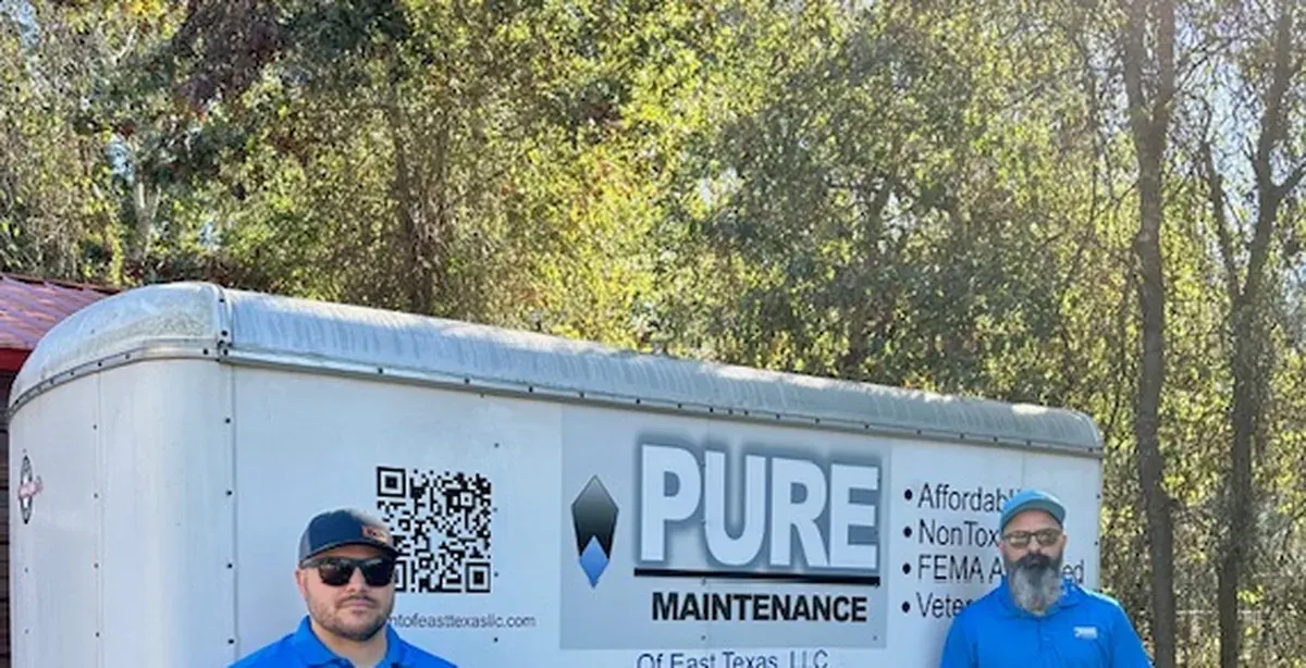 The Pure Maintenance of East Texas team beside their equipment trailer in Kilgore, TX
