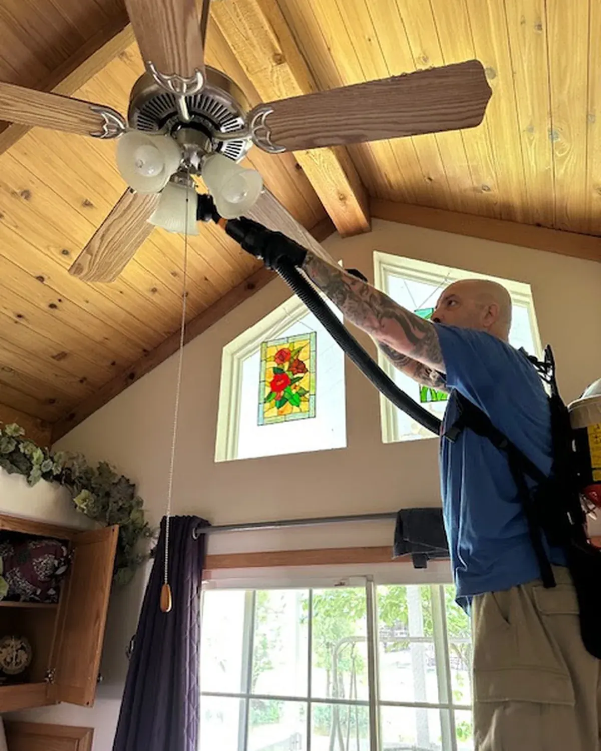 A Pure Maintenance of East Texas technician applying the dry fog treatment inside an East Texas home