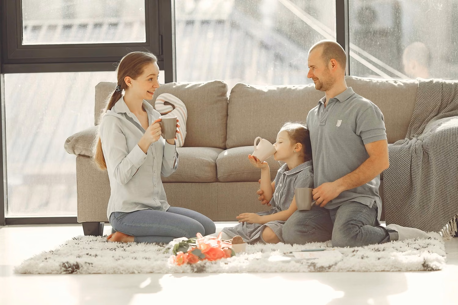A family together in a bright, window-lit living room